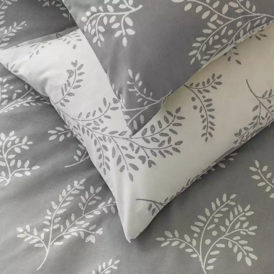 Gray and white floral patterned bedding set on a plain background