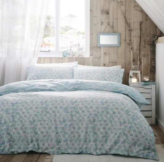 Each side depicting a delicate coastal texture in a soft duck egg tone on a warm sandy base