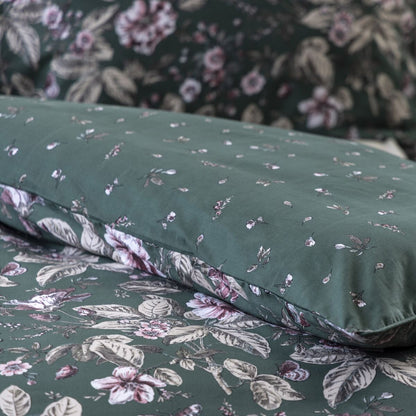 Floral-patterned bed sheets on a bed with a nightstand in the background.