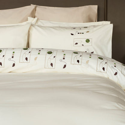 Bed with patterned bedding and pillows in a bedroom setting.