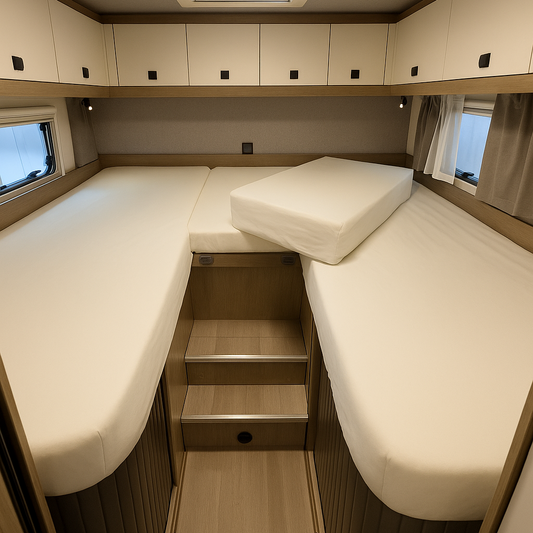 Compact bedroom setup with a bed, storage steps, and skylights in a small living space.