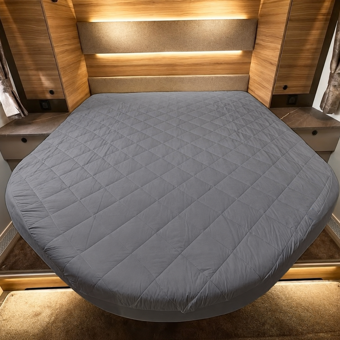 Grey Mattress protector on island shaped bed