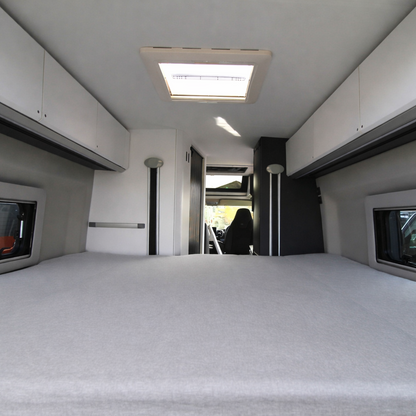 Interior of an Adria SGX campervan with a fitted sheet from Tuck Me Under