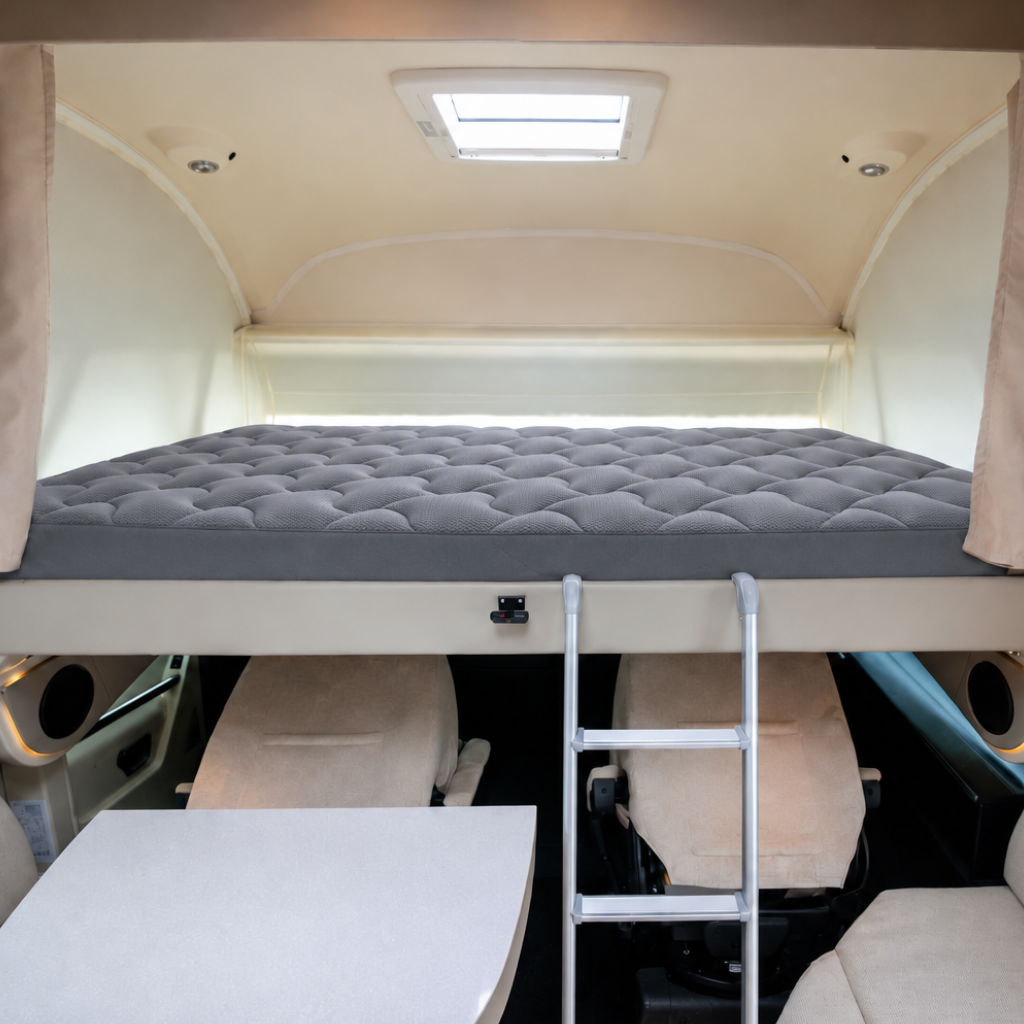 Motorhome drop down overcab bed with grey padded protector