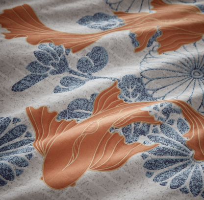 Koi fish gracefully float above an ornamental tiled floral background. An invigorating colour palette of mandarin orange and cool sky blue features over a chalk white ground