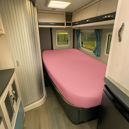 Compact living space with a pink mattress in a small room.