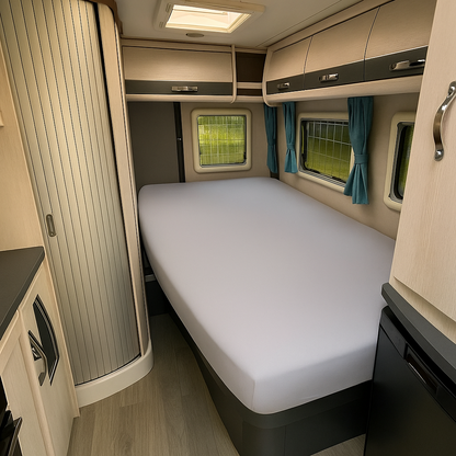 Compact bedroom interior with a bed, cabinets, and windows in a small living space.