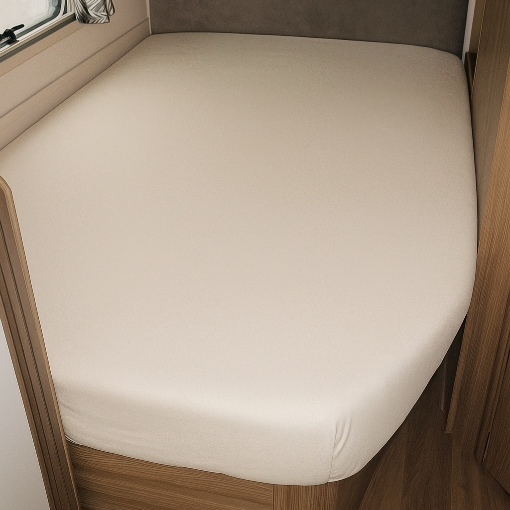 Bed in a compact living space with wooden frame and white mattress