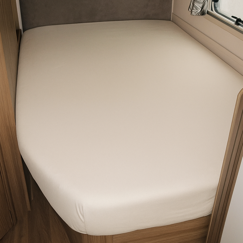 Bed in a compact living space with wooden frame and white mattress