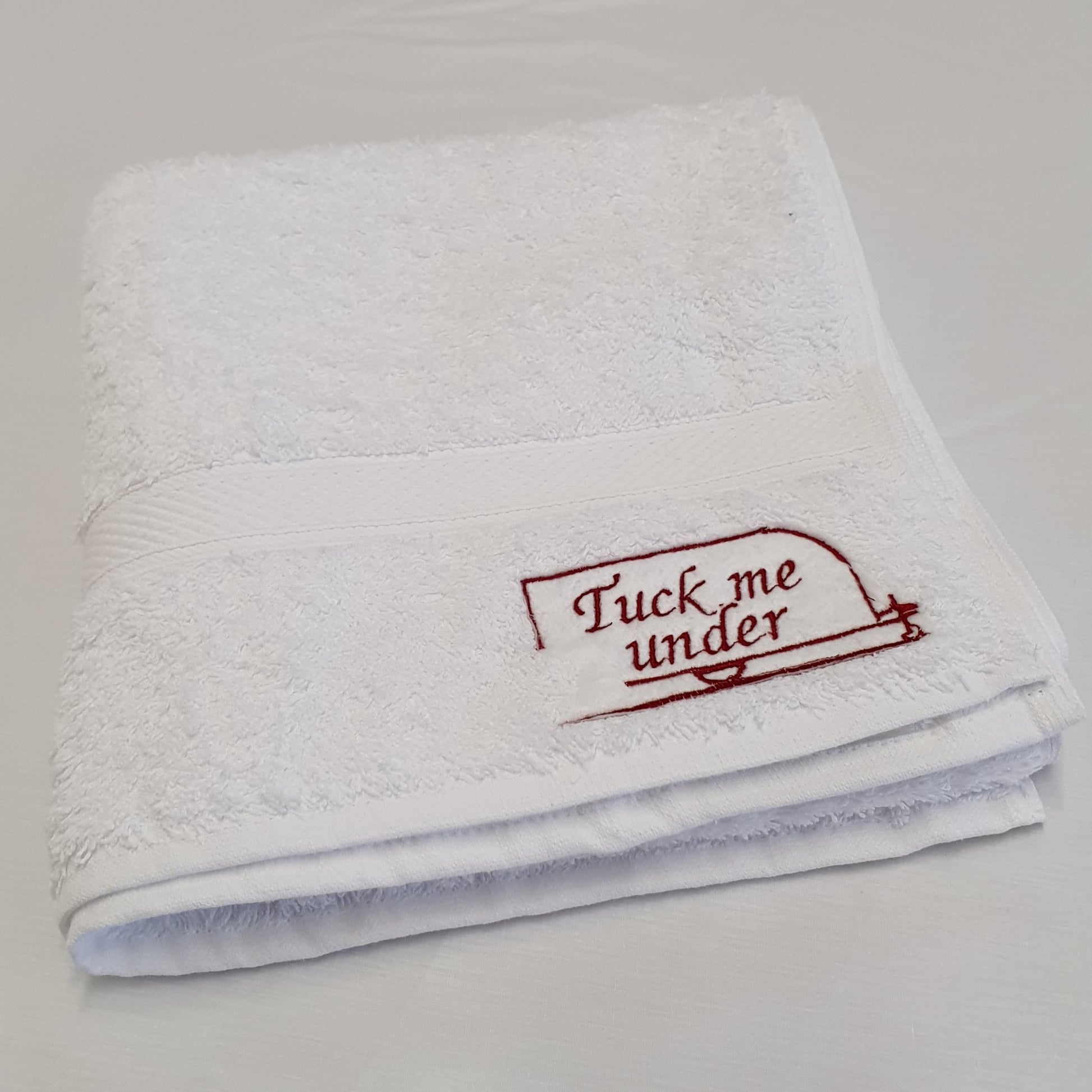 Hand towel with embroidered caravan